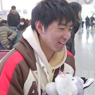 叔叔抱着送小侄儿的小狗公仔返乡